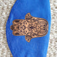 Hamsa face Cover , on Israeli blue background, metallic gold printed design, pocket filter face mask, adjustable ear straps with clips