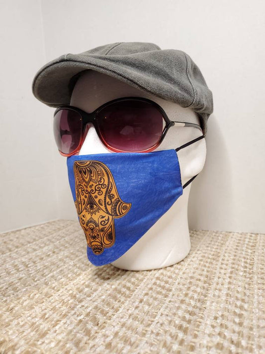 Hamsa face Cover , on Israeli blue background, metallic gold printed design, pocket filter face mask, adjustable ear straps with clips